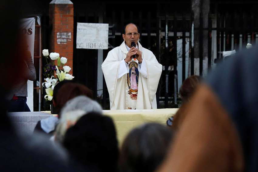  Father Alejandro Solalinde, a human rights activist, celebrates an outdoor Mass Jan. 11 in Mexico City. Presidential front-runner Andres Manuel Lopez Obrador of the National Regeneration Movement said he will appoint the priest human rights director if elected president. 