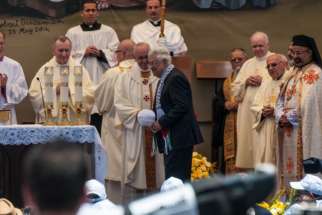 Pope Francis shakes hands with Palestinian President Mahmoud Abbas.
