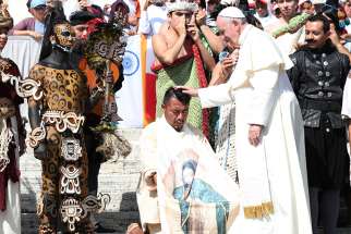 Pope Francis blesses a man from the Mexican state of Quintana Roo during his general audience in St. Peter&#039;s Square Aug. 29 at the Vatican.