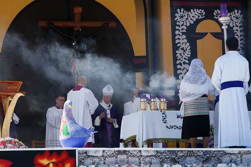 An indigenous woman holds burning incense as Pope Francis celebrates Mass with the indigenous community from Chiapas in San Cristobal de Las Casas, Mexico, Feb. 15. 