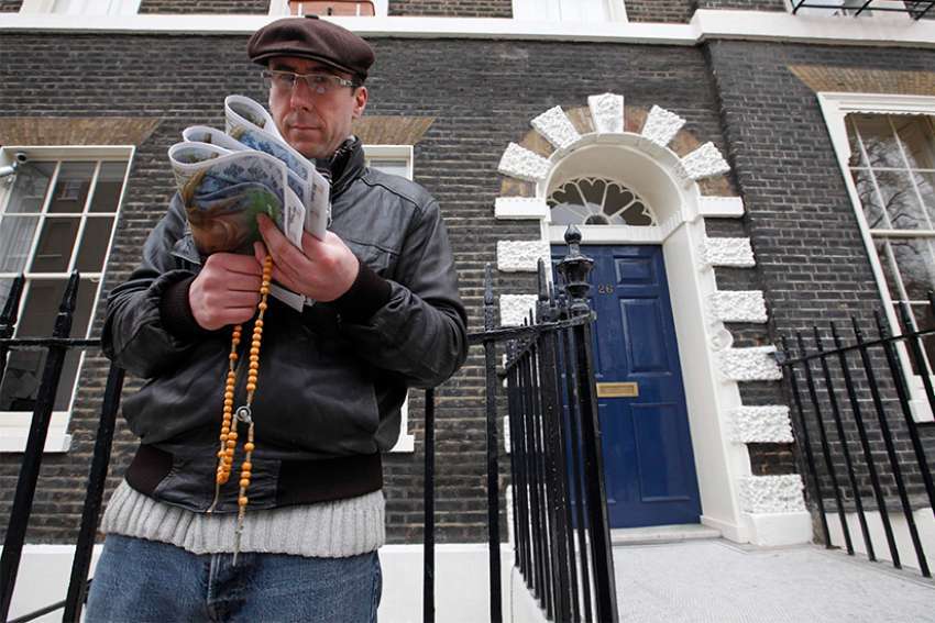 A pro-life activist holds a rosary outside an abortion clinic in 2012 in London. Auxiliary Bishop John Sherrington of Westminster praised a decision by the British government not to impose exclusion zones around abortion clinics throughout the country. 