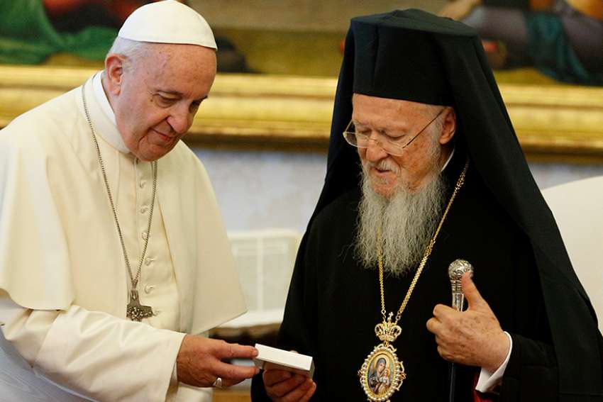 Pope Francis presents a gift to Ecumenical Patriarch Bartholomew of Constantinople during a meeting in the Apostolic Palace at the Vatican May 26. 