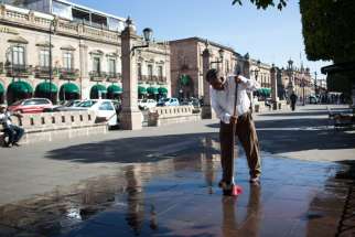 A man cleans the sidewalk Dec. 17 in Morelia, Mexico, in preparation for Christmas. Pope Francis is scheduled to visit Morelia, as well as other Mexican cities, during his Feb. 12-17 visit. 