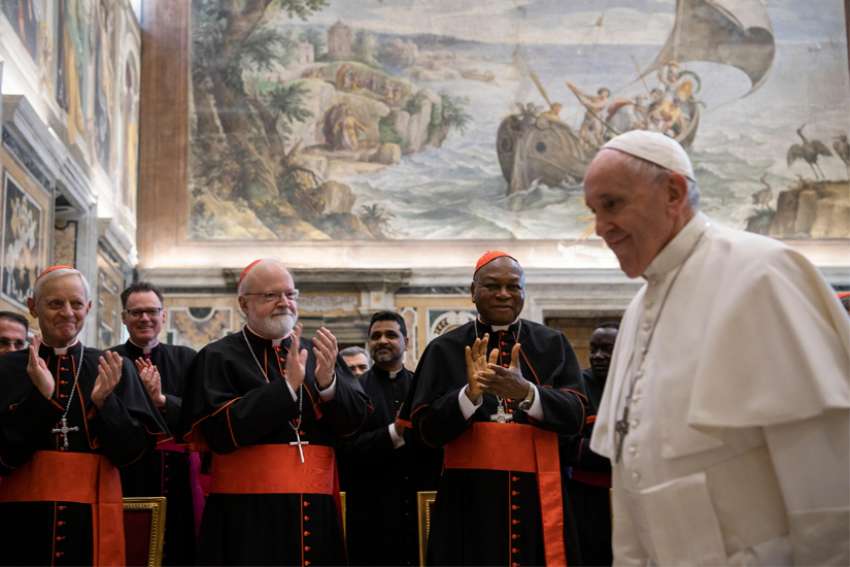 Members of the Congregation for the Doctrine of the Faith -- Cardinal Donald W. Wuerl, retired archbishop of Washington; Cardinal Sean P. O&#039;Malley of Boston; and Nigerian Cardinal John Olorunfemi Onaiyekan, retired archbishop of Abuja -- applaud Pope Francis at the end of an audience with members of the Congregation for the Doctrine of the Faith Jan. 30, 2020, at the Vatican.