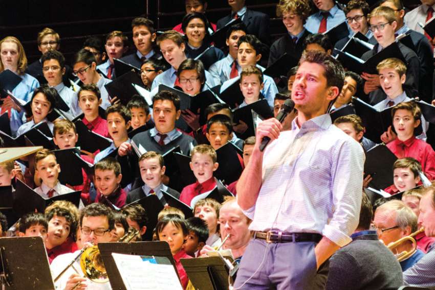 Choir school alumnus Matt Dusk sings with St. Michael’s Choir School as they rehearse for their annual Christmas concert at Massey Hall.