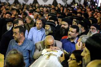 Mourners attend the April 10 funeral for victims of a bomb attack the previous day at the Orthodox Church of St. George in Tanta, Egypt. Also April 9, an explosion went off outside the Cathedral of St. Mark in Alexandria where Coptic Orthodox Pope Tawadros II was presiding over the Palm Sunday service.