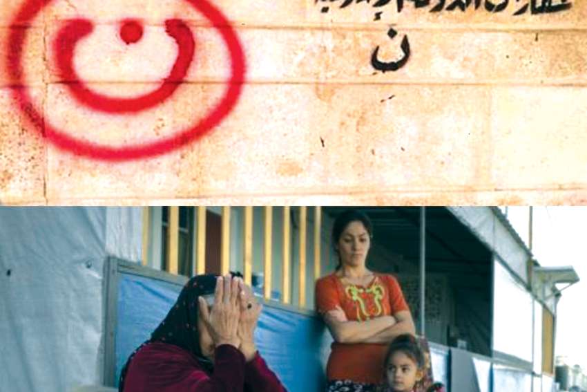The letter “N” in Arabic, for Nazarene or Christian, hangs over the door of an Iraqi Christian family’s home in Mosul, Iraq. It signifies ISIS has targetted the family for extermination. The family was forced to flee.