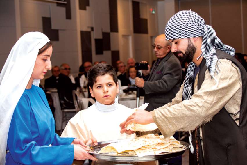 In the traditional dress of Iraq’s indigenous Chaldeans, Anta Alantwan, Antonues Polo and Suhel Bawood distributed bread and salt to begin the 2018 Christians in the Middle East Benefit Dinner, this year focussing on Iraq. 