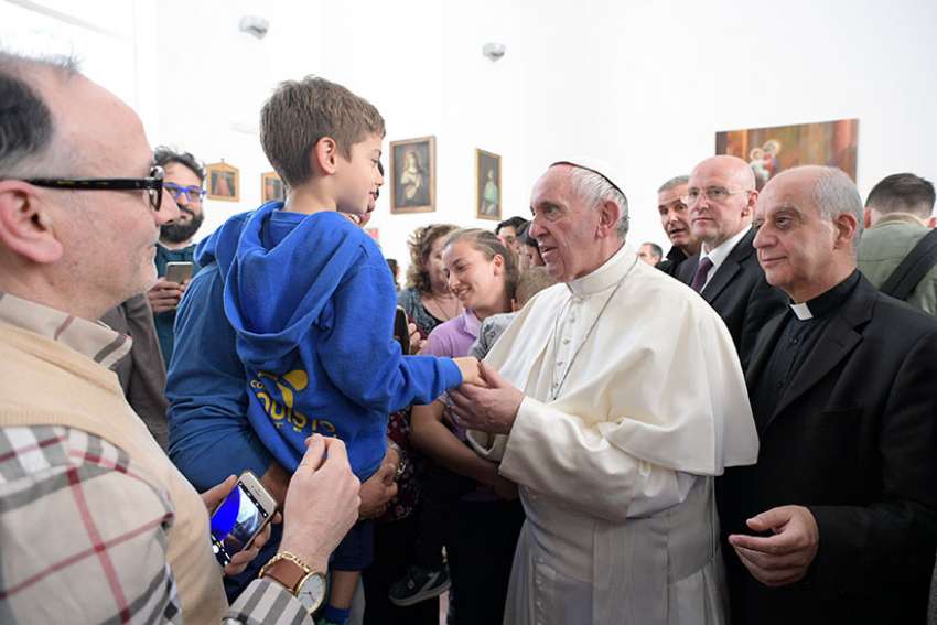 Pope Francis greets a child as he visits the Sant&#039; Alessio-Margherita di Savoia Regional Center for the Blind March 31 in Rome.