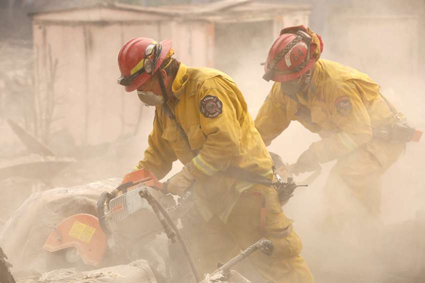 California firefighters comb through a house Nov. 13 destroyed by the Camp Fire in Paradise, Calif. 