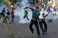Demonstrators confront police during a protest against the government of President Nicolas Maduro in Caracas, Venezuela, Feb. 22. The country&#039;s Catholic leaders urged dialogue and respect for the demonstrators&#039; human rights.