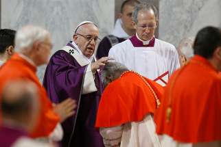 02.14.2018  Pope Francis places ashes on the head of a cardinal during Ash Wednesday Mass at the Basilica of Santa Sabina in Rome Feb. 14. 