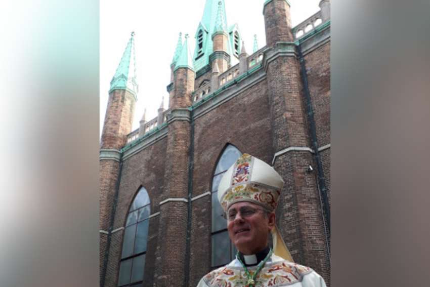 Bishop Ronald Fabbro in front of Our Lady of the Assumption church in Windsor.