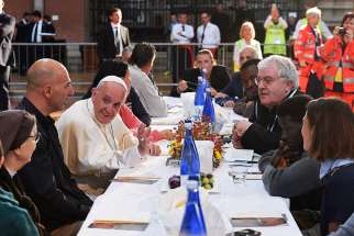 Pope Francis eats lunch with the poor, refugees and detainees in the Basilica of San Petronio in Bologna, Italy, Oct. 1.