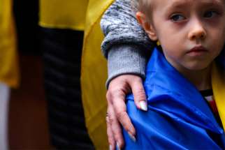 A child in New York City is comforted March 19, 2022, during a Mothers March against the Russian invasion of Ukraine.