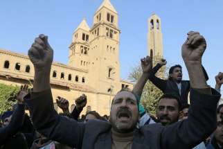 Christians chant anti-terrorism slogans outside the Coptic Orthodox cathedral complex Dec. 11 after an explosion inside the complex in Cairo. 