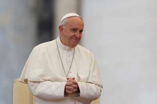 Pope Francis smiles as he leads his general audience in St. Peter&#039;s Square at the Vatican Oct. 26.