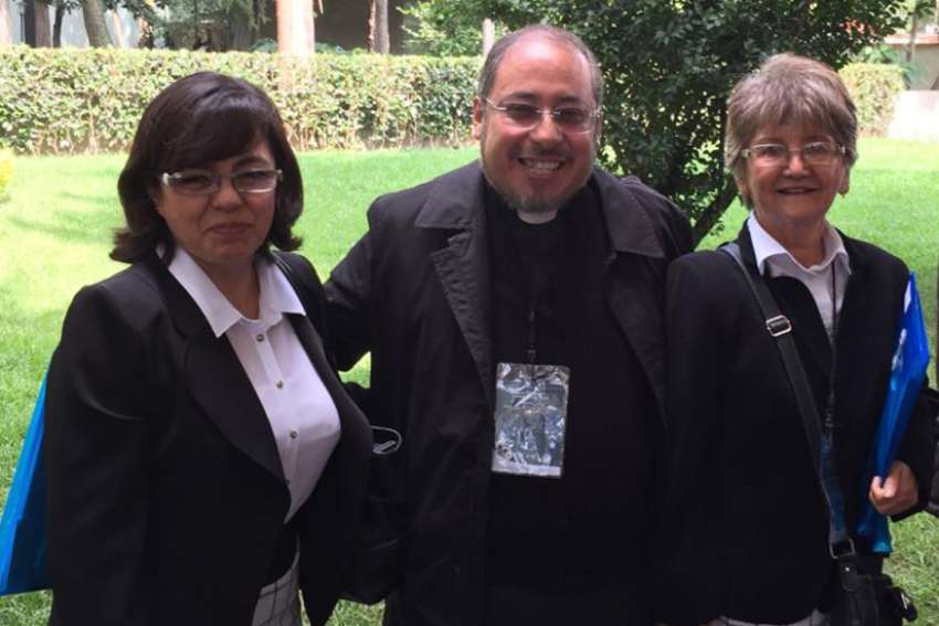 Father Ruben Alcantara Diaz, pastor of Our Lady of Carmen Parish in Cuautitlan Izcalli, Mexico, was stabbed to death in his parish April 18. He is pictured with two unidentified women in 2015 in Mexico City. 