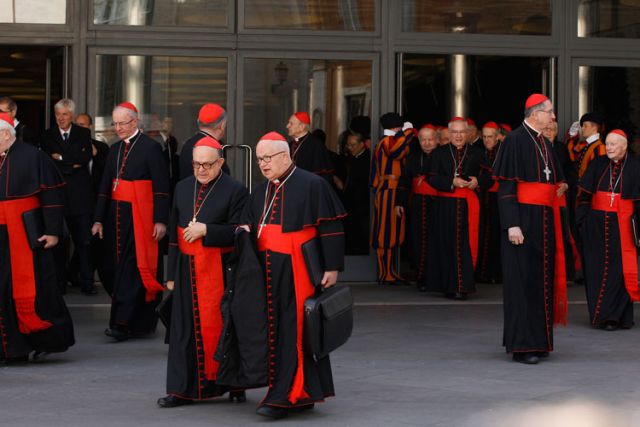 Cardinals leave a meeting with Pope Francis in the synod hall at the Vatican Feb. 21.