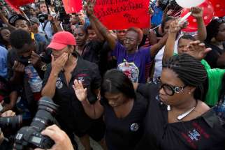 Community members attend a July 7 vigil in memory of Alton Sterling, who was shot dead by police outside a market in Baton Rouge, La. Sterling, 37, was killed early July 5 in a shooting that was captured on cellphone video.