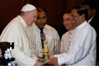 Pope Francis accepts a gift from Sri Lankan President Maithripala Sirisena during a visit in a presidential office in Colombo, Sri Lanka, Jan. 13.
