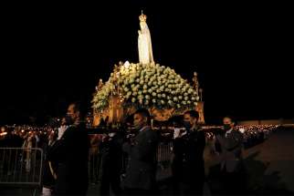 A statue of Mary is seen May 12 at the Marian shrine of Fatima in central Portugal. Thousands of pilgrims arrived at the shrine to attend the 104th anniversary of the first apparition of Mary to three shepherd children May 13.