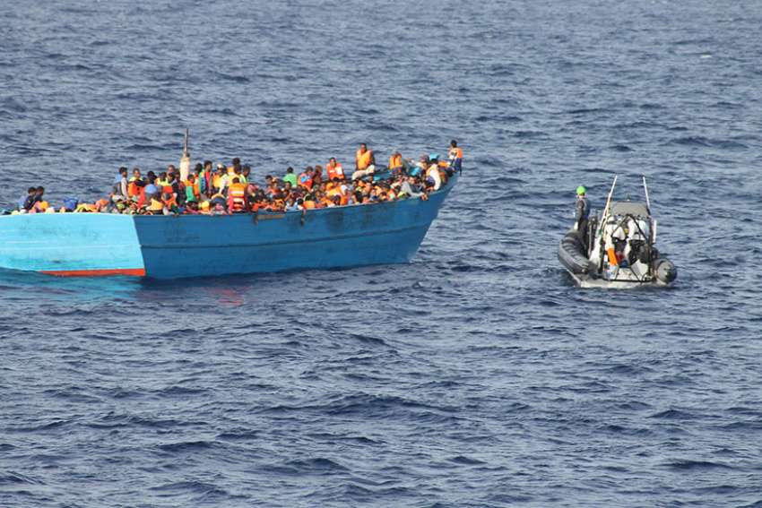 The Irish Naval Service approach a boat filled with migrants Oct. 21, 2016 in the Mediterranean Sea off the coast of Tripoli, Libya. 245 were feared dead or missing from two shipwrecks in the Mediterranean Sea over the weekend. 