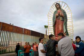 A file photo shows a statue of Our Lady of Guadalupe as it is unloaded from a truck after a procession to the U.S.-Mexico border fence in Tijuana, Mexico, where Mass was celebrated. Pope Francis has asked Catholics to add &quot;Comfort of Migrants&quot; and two other titles for Mary to the popular &quot;Litany of Loreto.&quot;