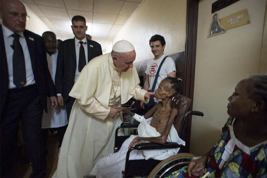 Pope Francis greets a patient at a pediatric center in Bangui, Central African Republic, in this Nov. 29, 2015, file photo. 