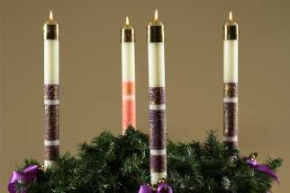Candles are lit on a wreath during the fourth week of Advent.