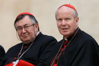 Cardinal Vinko Puljic of Sarajevo, Bosnia-Herzegovina, and Cardinal Christoph Schonborn of Vienna, Austria, attend Pope Francis&#039; general audience in St. Peter&#039;s Square at the Vatican in 2018. Cardinal Puljic said he received threats for celebrating a mid-May Mass for victims of a post-World War II massacre. The Mass is normally celebrated in an Austrian border town but was held in Sarajevo because of restrictions from the COVID-19 pandemic.