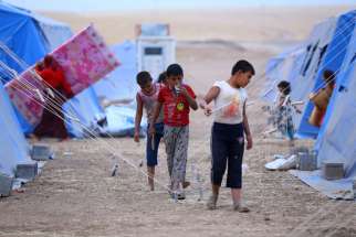 Iraqi refugees are seen in a camp near the northern city of Irbil June 12. Hundreds of thousands of people who have fled their homes in Mosul are left without access to aid, officials said. Christians from the city say they were targeted long before Iraq i security forces abandoned the major political and economic hub.