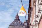 The Vatican flag, left, flies over a Vatican office building in Rome. When the Vatican speaks, people listen. Diplomats from the Holy See may be few, but they are influential on the world scene.