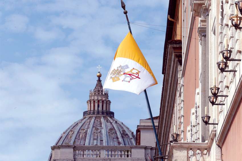 The Vatican flag, left, flies over a Vatican office building in Rome. When the Vatican speaks, people listen. Diplomats from the Holy See may be few, but they are influential on the world scene.