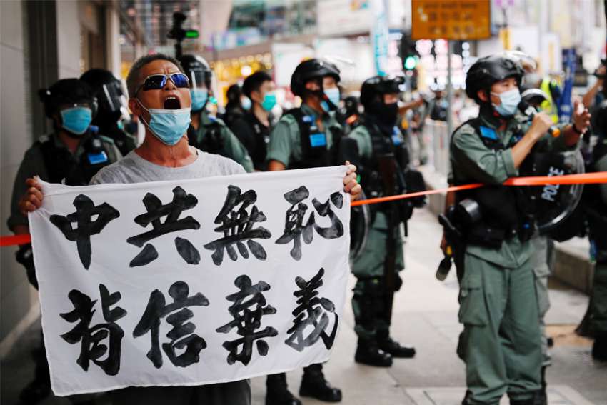 A man holding a banner reading &quot;Chinese communist party is shameless, break the promises,&quot; shouts during a protest against the new national security law in Hong Kong July 1, 2020.