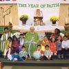 Fr. Massey Lombardi sits with a few children clad in the traditional garments of their heritage following the Oct. 14 Mass that kicked off the Year of Faith at Toronto’s St. Wilfrid’s parish.