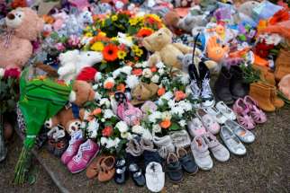 Children&#039;s shoes line a memorial on the grounds of the former Kamloops Indian Residential School June 6, 2021. The remains of 215 children, some as young as 3 years old, were found at the site in May in Kamloops, British Columbia.
