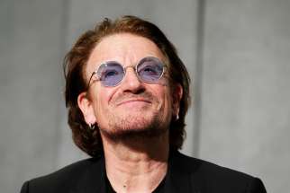 Bono, the lead singer of U2, speaks during a news conference in the Vatican press hall after meeting Pope Francis at the Vatican Sept. 19.