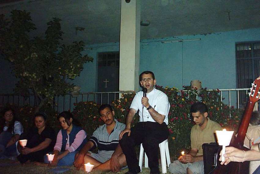 Father Ragheed Aziz Ganni, who was killed for the faith June 3, 2007 in Mosul, is seen with a group of young adults