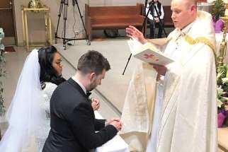 Fr. Mark McGuckin performs the marriage ceremony for Danda Santos and Mark Witecki, which took place shortly after Witecki was confirmed at the Easter Vigil at St. Joseph’s Church in  Port Moody, B.C.