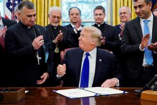 Chaldean Catholic Archbishop Bashar Warda of Irbil, Iraq, holds the pen given to him by U.S. President Donald Trump Dec. 11 after Trump used it to sign into law the Iraq and Syria Genocide Relief and Accountability Act of 2018 at the White House in Washington. The bill will provide humanitarian relief to genocide victims in Iraq and Syria and hold accountable Islamic State perpetrators of genocide. 