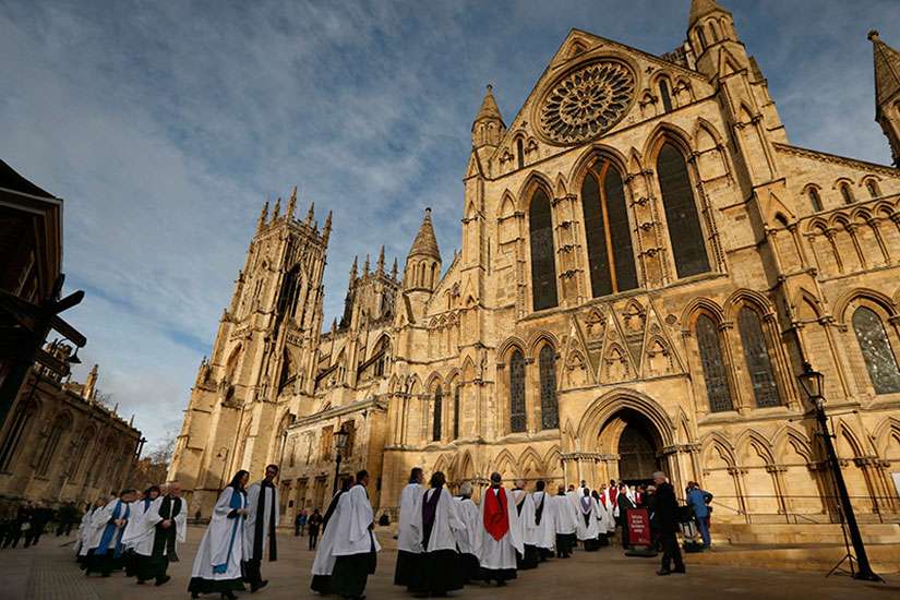 Members of the clergy enter York Minster before a service to consecrate the Rev. Libby Lane as the first female bishop in the Church of England, in York, northern England, on Jan. 26, 2015.