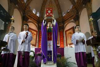 A Catholic priest celebrates Sunday Mass in Beijing in this Dec. 4, 2016, file photo. In a special message addressed &quot;to the Catholics of China and to the universal church,&quot; released by the Vatican Sept. 26, Pope Francis said he hoped a recent Sin-Vatican agreement would help &quot;restore full communion among all Chinese Catholics.&quot;