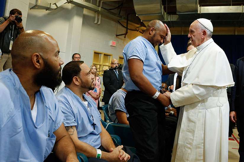 Pope Francis blesses a prisoner as he visits the Curran-Fromhold Correctional Facility in Philadelphia Sept. 27.