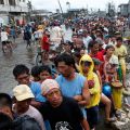 Typhoon victims wait in line for free rice at a businessman&#039;s warehouse in Tacloban, Philippines, which was devastated by Super Typhoon Haiyan. Aid agencies faced challenges getting food and water to the hundreds of thousands of Filipinos affected by the storm.