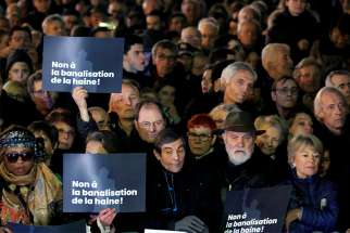 People attend a national gathering in Paris Feb. 19, 2019, to protest the rise of anti-Semitic attacks. The placards read: &quot;No to the trivialization of hatred.&quot; 