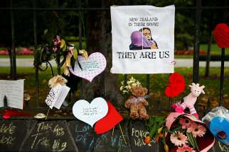 Flowers and signs are seen at the Botanic Gardens in Christchurch, New Zealand, in a makeshift memorial March 18, 2019. Such memorials and prayer services could be found across the country and abroad after two mosque attacks in Christchurch, New Zealand, March 15 that left at least 50 people dead and 20 seriously injured. 