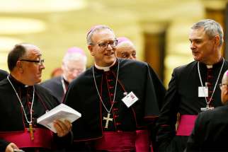  Los Angeles Auxiliary Bishop Robert E. Barron, centre, leaves the opening session of the Synod of Bishops on young people, the faith and vocational discernment at the Vatican Oct 3.