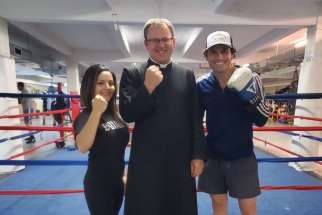 St. Ann’s pastor Fr. Jeff Oehring in the ring with McGrory’s Boxing Club owners Maria and Lawrence Hay. The famed club is housed at east end Hamilton’s St. Ann’s Parish and is hosting a fundraiser for the parish’s 100-year anniversary later this month.