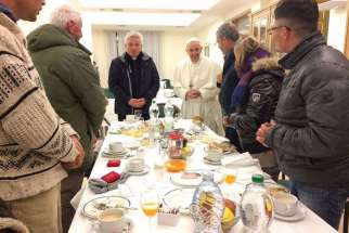 Pope Francis eats breakfast with a group of homeless for his 80th birthday, Dec. 17.